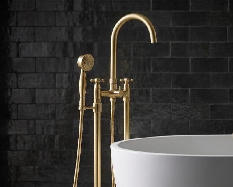 Unlacquered brass freestanding floor-mount tub filler with hand shower